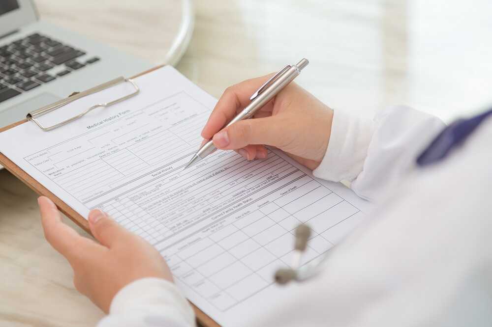 close-up-physician-s-hands-with-clipboard-pen_optimized